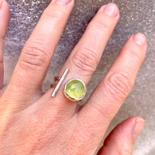 Load image into Gallery viewer, Hand wearing a ring with a prehnite gemstone